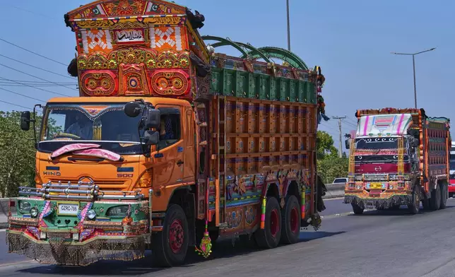 Trucks decorated with artwork drive along a highway on the outskirts of Islamabad, Pakistan, on Sunday, April 27, 2025. (AP Photo/Anjum Naveed)