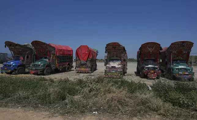 Trucks decorated with artwork are parked at a terminal on the outskirts of Islamabad, Pakistan, on Sunday, April 27, 2025. (AP Photo/Anjum Naveed)