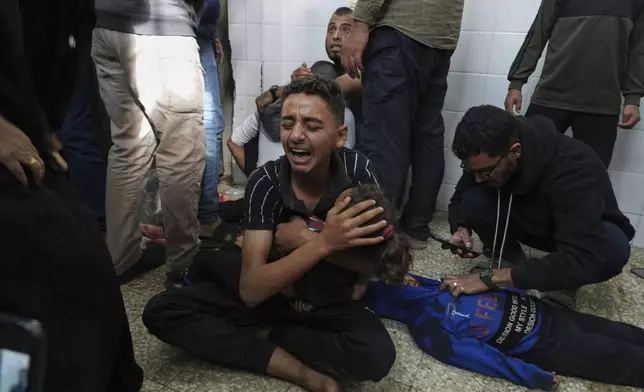 CORRECTS NAMES.- Mohammed ''Samy" Abed, center, mourns his sister Masha Abed, 4, who was killed in an Israeli army airstrike on the Gaza Strip, at the morgue of Al-Aqsa Hospital in Deir al-Balah, Gaza, Sunday, April 27, 2025. (AP Photo/Abdel Kareem Hana)