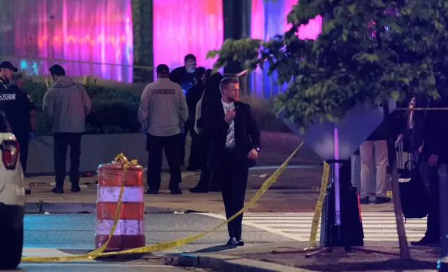 Law enforcement work the scene after two staff members of the Israeli Embassy in Washington were shot and killed outside the Capital Jewish Museum, Thursday, May 22, 2025, in Washington.. (AP Photo/Rod Lamkey, Jr.)