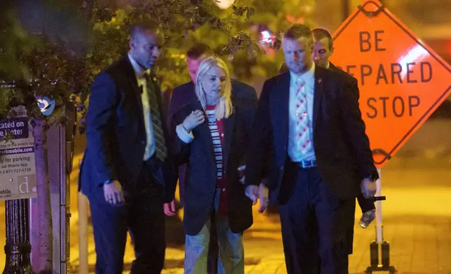Attorney General Pam Bondi, center, walks to her car as law enforcement work the scene after two staff members of the Israeli Embassy in Washington were shot and killed outside the Capital Jewish Museum, Thursday, May 22, 2025, in Washington. (AP Photo/Rod Lamkey, Jr.)