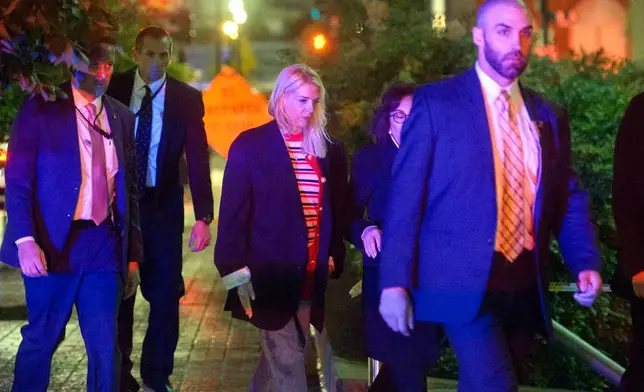 Attorney General Pam Bondi, center, walks to her car as law enforcement work the scene after two staff members of the Israeli Embassy in Washington were shot and killed outside the Capital Jewish Museum, Thursday, May 22, 2025, in Washington. (AP Photo/Rod Lamkey, Jr.)