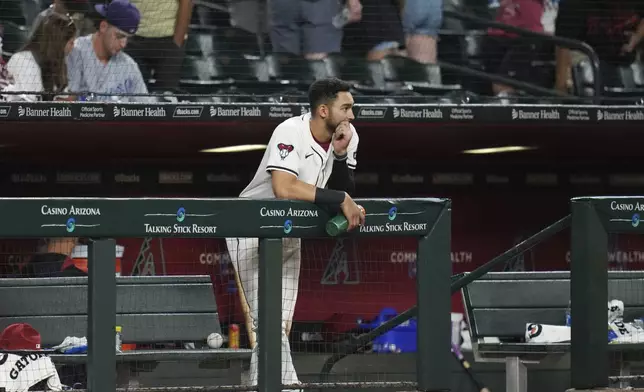 Arizona Diamondbacks' Jordan Lawlar pauses at the top of the dugout after a baseball game loss against the Pittsburgh Pirates Tuesday, May 27, 2025, in Phoenix. (AP Photo/Ross D. Franklin)