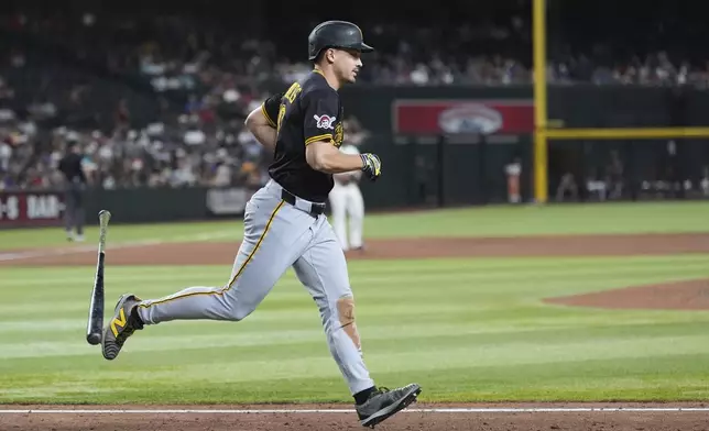 Pittsburgh Pirates' Bryan Reynolds flips his bat as he starts rounding the bases after hitting a three-run home run against the Arizona Diamondbacks during the eighth inning of a baseball game Tuesday, May 27, 2025, in Phoenix. (AP Photo/Ross D. Franklin)