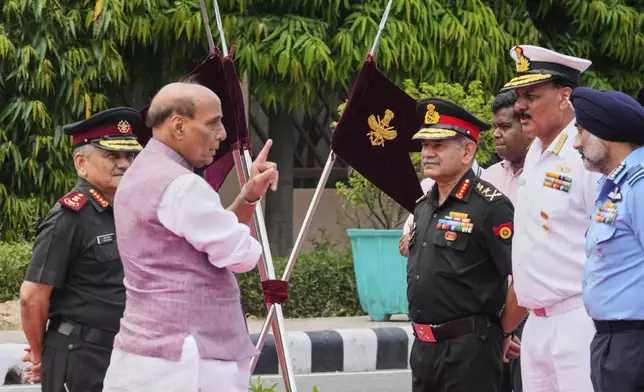 Indian Defense Minister Rajnath Singh, second left, talks to three Indian defense chiefs, Army General Upendra Dwivedi, third right, Naval Admiral Dinesh K Tripathi, second right, and Air Force Air Chief Marshal A P Singh, right, as Indian Chief of Defense Staff General Anil Chauhan, left, watches as they wait for the arrival of Japan's Defense Minister Gen Nakatani in New Delhi, India, Monday, May 5, 2025.(AP Photo/Manish Swarup)