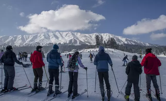 FILE - Tourists wait for their turn to use a ski-lift to transport them up a slope in Gulmarg, northwest of Srinagar, Indian controlled Kashmir, Jan. 10, 2021. (AP Photo/Dar Yasin, File)