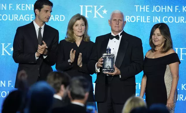 Former Vice President Mike Pence, second from right, stands with his wife, Karen Pence, far right, as he is presented with the John F. Kennedy Profile in Courage Award by Jack Schlossberg and his mother, Caroline Kennedy, at a ceremony at the JFK Library, Sunday, May 4, 2025, in Boston. (AP Photo/Robert F. Bukaty)