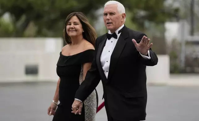 Former Vice President Mike Pence arrives with his wife, Karen Pence, at the JFK Library where he will receive the John F. Kennedy Profile in Courage Award, Sunday, May 4, 2025, in Boston. (AP Photo/Robert F. Bukaty)