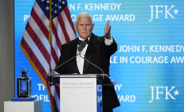 Former Vice President Mike Pence acknowledges his staff members as he speaks after receiving the John F. Kennedy Profile in Courage Award during a ceremony at the JFK Library, Sunday, May 4, 2025, in Boston. (AP Photo/Robert F. Bukaty)