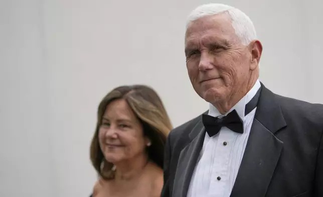 Former Vice President Mike Pence arrives with his wife, Karen Pence, at the JFK Library where he will receive the John F. Kennedy Profile in Courage Award, Sunday, May 4, 2025, in Boston. (AP Photo/Robert F. Bukaty)