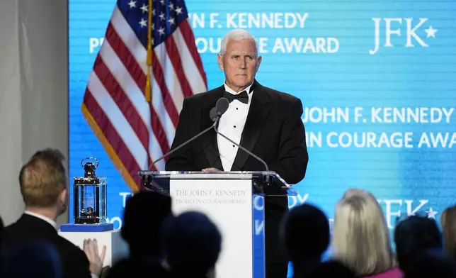 Former Vice President Mike Pence acknowledges a standing ovation as he speaks after receiving the John F. Kennedy Profile in Courage Award during a ceremony at the JFK Library, Sunday, May 4, 2025, in Boston. (AP Photo/Robert F. Bukaty)