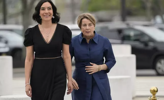 Massachusetts Gov. Maura Healey, right, and her partner, Joanna Lydgate, arrive at the JFK Library, Sunday, May 4, 2025, in Boston. (AP Photo/Robert F. Bukaty)