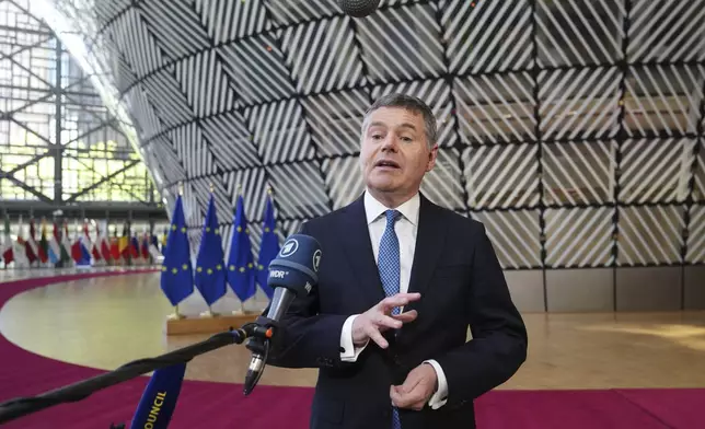 President of the Eurogroup Paschal Donohoe speaks with the media as he arrives for a meeting of eurogroup finance ministers at the European Council building in Brussels, Monday, May 12, 2025. (AP Photo/Virginia Mayo)
