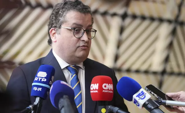 Portugal's Economy Minister Joao Leao speaks with the media as he arrives for a meeting of eurogroup finance ministers at the European Council building in Brussels, Monday, May 12, 2025. (AP Photo/Virginia Mayo)