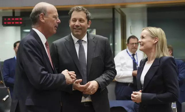 Germany's Finance Minister Lars Klingbeil, center, speaks with French Finance Minister Eric Lombard, left, and Finland's Finance Minister Riikka Purra during a meeting of eurogroup finance ministers at the European Council building in Brussels, Monday, May 12, 2025. (AP Photo/Virginia Mayo)