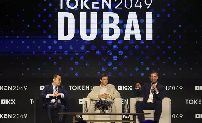 Eric Trump, Executive VP of The Trump Organization, right, speaks as Co-founder of World Liberty Financial Zach Witkoff, centre, and Founder of TRON Justin Sun look on during Token 2049, a Crypto event, in Dubai, United Arab Emirates, Thursday, May 1, 2025. (AP Photo/Altaf Qadri)