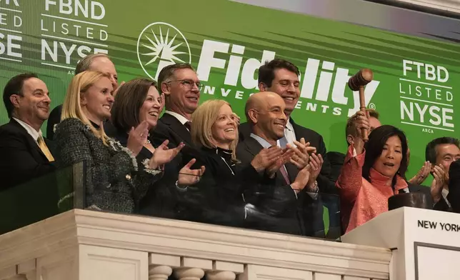 Fidelity Investments Head of Fixed Income Robin Foley, right, gavels trading closed at the New York Stock Exchange, Monday, May 12, 2025. (AP Photo/Richard Drew)