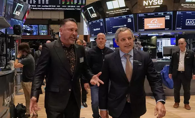 Oscar De La Hoya, left, Chairman &amp; CEO of Golden Boy Promotions, walks with Chris Taylor, NYSE Vice President of Listings, on the floor of the New York Stock Exchange before ringing the opening bell, Friday, May 2, 2025. (AP Photo/Richard Drew)
