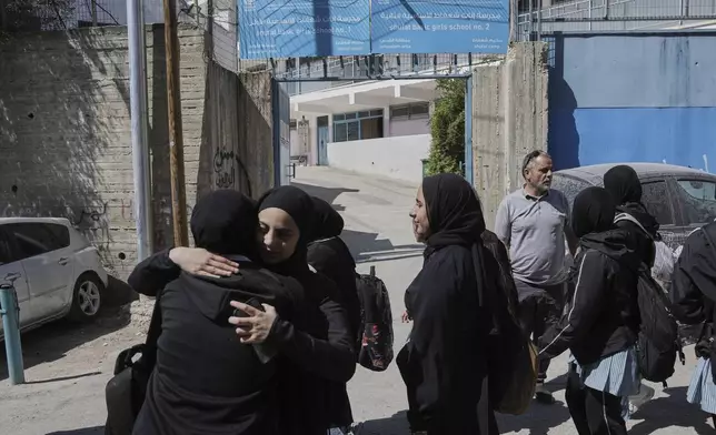 Students stand outside of UNRWA Girls School run by the U.N. agency for Palestinian refugees in the Shuafat Refugee Camp in east Jerusalem, Thursday, May 8, 2025. After Israeli forces ordered the closure of six of its schools in east Jerusalem Thursday. (AP Photo/Mahmoud Illean)