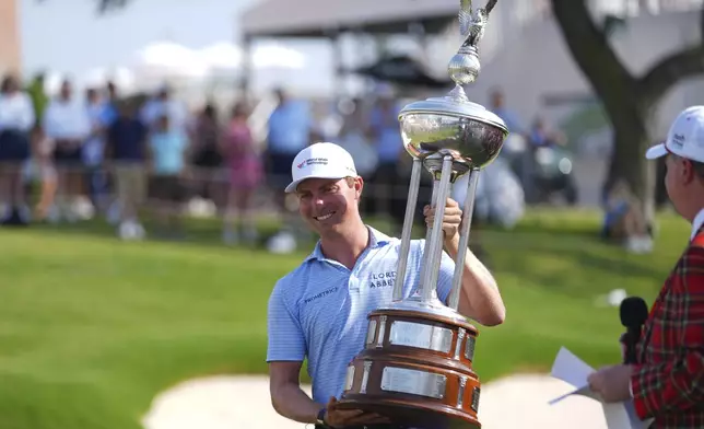 Ben Griffin celebrates after winning the Charles Schwab Challenge golf tournament at Colonial Country Club in Fort Worth, Texas, Sunday, May 25, 2025. (AP Photo/Julio Cortez)