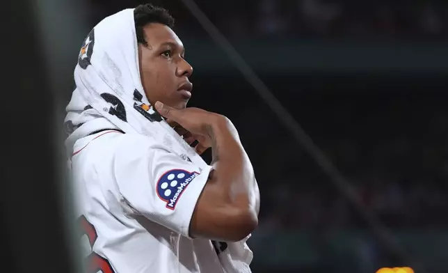 Boston Red Sox starting pitcher Brayan Bello watches from the dugout during the seventh inning of a baseball game against the Minnesota Twins at Fenway Park, Friday, May 2, 2025, in Boston. (AP Photo/Charles Krupa)