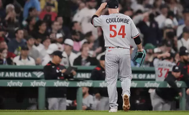 Minnesota Twins pitcher Danny Coulombe heads to the dugout during the seventh inning of a baseball game against the Boston Red Sox at Fenway Park, Friday, May 2, 2025, in Boston. (AP Photo/Charles Krupa)
