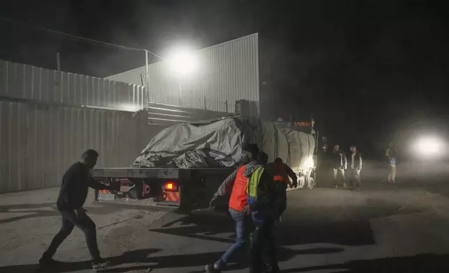 Aid trucks carrying food arrive at a World Food Program warehouse in Zawaida, central Gaza Strip, Wednesday, May 21, 2025. (AP Photo/Abdel Kareem Hana)