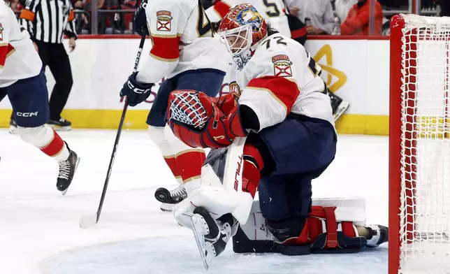 Florida Panthers goaltender Sergei Bobrovsky (72) blocks a shot from the Carolina Hurricanes during the second period of Game 1 of the NHL hockey Stanley Cup Eastern Conference finals in Raleigh, N.C., Tuesday, May 20, 2025. (AP Photo/Karl DeBlaker)