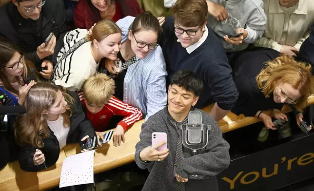 JJ, center, from Austria arrives at the airport in Vienna, Austria, Sunday, May 18, 2025, after winning the Grand Final of the 69th Eurovision Song Contest, in Basel yesterday. (AP Photo/Denes Erdos)