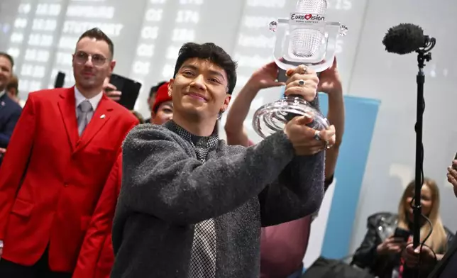 JJ, center, from Austria arrives at the airport in Vienna, Austria, Sunday, May 18, 2025, after winning the Grand Final of the 69th Eurovision Song Contest, in Basel yesterday. (AP Photo/Denes Erdos)