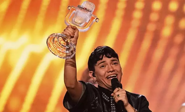 Winner of the Eurovision Song Contest JJ from Austria holds up the trophy onstage he won with the song "Wasted Love" during the Grand Final of the 69th Eurovision Song Contest, in Basel, Switzerland, early Sunday, May 18, 2025. (AP Photo/Martin Meissner)