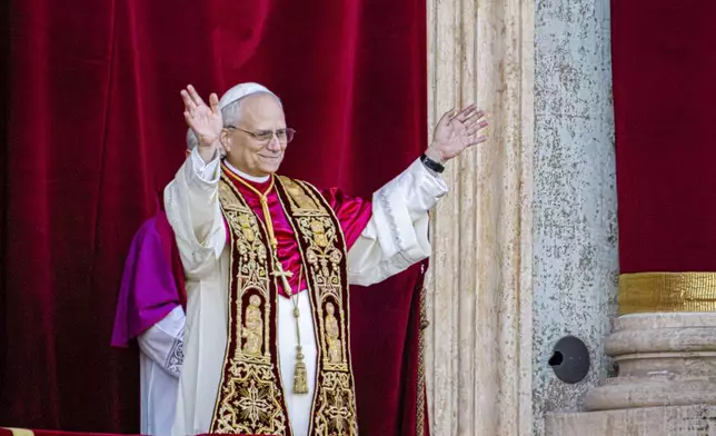 Newly elected Pope Leo XIV, formerly Cardinal Robert Francis Prevost, appears on the central loggia of St. Peter's Basilica at the Vatican shortly after his election as the 267th pontiff of the Roman Catholic Church, Thursday, May 8, 2025. (AP Photo/Domenico Stinellis)