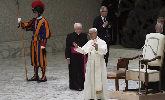 Pope Leo XIV arrives as he meets members of the international media in the Paul VI Hall at the Vatican, Tuesday, May 13, 2025. (AP Photo/Domenico Stinellis)