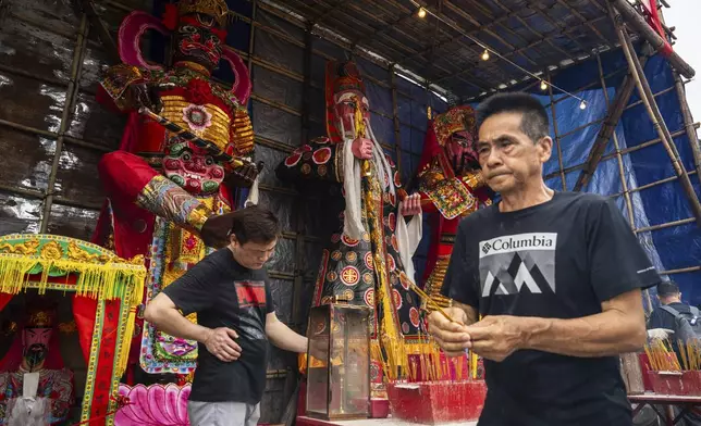 Paper offerings are displayed at a temple during the Bun Festival in Cheung Chau Island in Hong Kong, Monday, May 5, 2025. (AP Photo/Chan Long Hei)