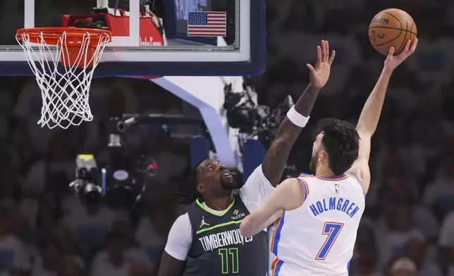 Oklahoma City Thunder forward Chet Holmgren (7) shoots against Minnesota Timberwolves center Naz Reid (11) during the first half of Game 1 of an NBA basketball Western Conference Finals playoff series Tuesday, May 20, 2025, in Oklahoma City. (AP Photo/Nate Billings)