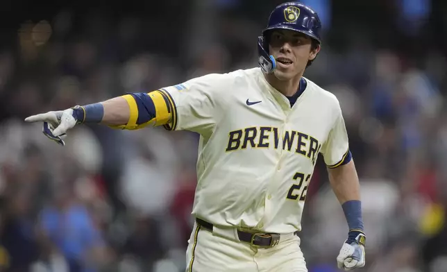 Milwaukee Brewers' Christian Yelich gestures after hitting a walk off grand slam during the 10th inning of a baseball game against the Boston Red Sox, Tuesday, May 27, 2025, in Milwaukee. (AP Photo/Aaron Gash)
