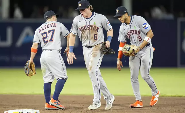 Houston Astros outfielder Jake Meyers (6) celebrates with outfielder Jose Altuve (27) and shortstop Jeremy Peña (3) after the team defeated the Tampa Bay Rays during a baseball game Monday, May 19, 2025, in Tampa, Fla. (AP Photo/Chris O'Meara)