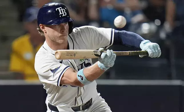 Tampa Bay Rays' Taylor Walls pops out to Houston Astros' Jose Altuve while attempting to bunt during the ninth inning of a baseball game Monday, May 19, 2025, in Tampa, Fla. (AP Photo/Chris O'Meara)