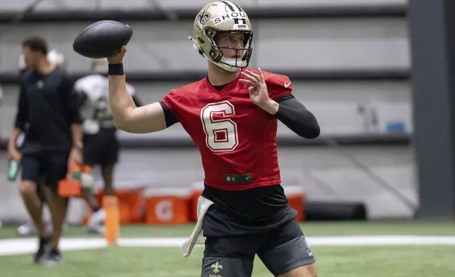 New Orleans Saints quarterback Tyler Shough (6) throws during NFL football practice in Metairie, La., Thursday, May 22, 2025. (AP Photo/Matthew Hinton)