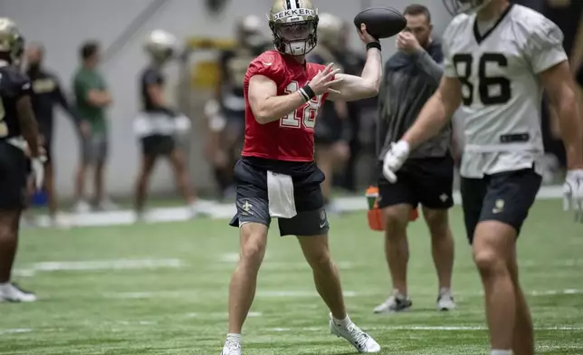 New Orleans Saints quarterback Hunter Dekkers (18) throws during NFL football practice in Metairie, La., Thursday, May 22, 2025. (AP Photo/Matthew Hinton)