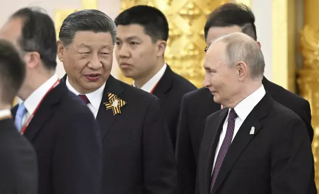 President of Russia Vladimir Putin, right, and President of China Xi Jinping talk during a dinner on behalf of the President of the Russian Federation for heads of foreign delegations in the Grand Palace at the Kremlin in Moscow, Thursday, May 8, 2025, ahead of celebrations of the 80th anniversary of the Soviet Union's victory over Nazi Germany during the World War II. (Sergey Bobylev/Photo host agency RIA Novosti via AP)