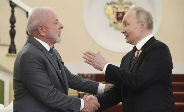 Russian President Vladimir Putin greets President of Brazil Luiz Inacio Lula da Silva, left, ahead of the Victory Day military parade in Moscow, Russia, Friday, May 9, 2025, marking the 80th anniversary of the Soviet Union's victory over Nazi Germany during the World War II. (Alexey Nikolsky/Sputnik, Kremlin Pool Photo via AP)