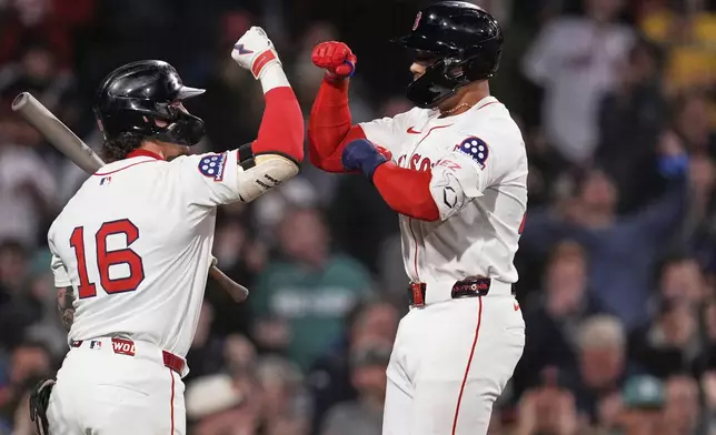 Boston Red Sox's Carlos Narvaez, right, is congratulated by Jarren Duran (16) after his solo home run against the New York Mets during the fifth inning of a baseball game at Fenway Park, Tuesday, May 20, 2025, in Boston. (AP Photo/Charles Krupa)