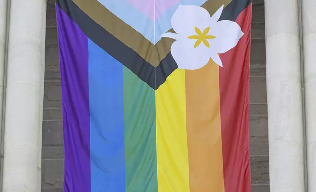 The newly adopted city flag is displayed at the Salt Lake City and County building showing support for LGBTQ+ in defiance of their state's Republican controlled Legislature, Wednesday, May 7, 2025, in Salt Lake City. (AP Photo/Melissa Majchrzak)