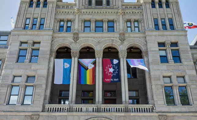 The newly adopted city flags are displayed at the Salt Lake City and County building showing support for LGBTQ+ in defiance of their state's Republican controlled Legislature, Wednesday, May 7, 2025, in Salt Lake City. (AP Photo/Melissa Majchrzak)