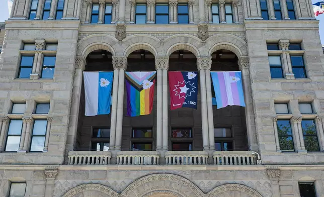 The newly adopted city flags are displayed at the Salt Lake City and County building showing support for LGBTQ+ in defiance of their state's Republican controlled Legislature, Wednesday, May 7, 2025, in Salt Lake City. (AP Photo/Melissa Majchrzak)