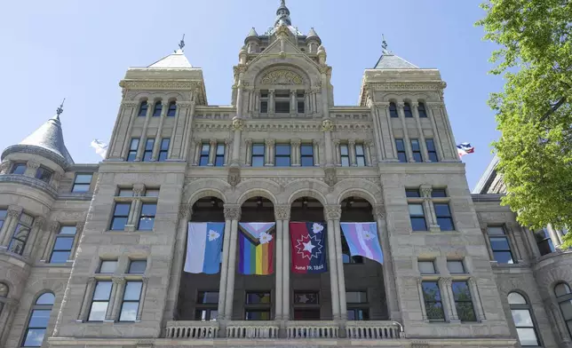 The newly adopted city flags are displayed at the Salt Lake City and County building showing support for LGBTQ+ in defiance of their state's Republican controlled Legislature, Wednesday, May 7, 2025, in Salt Lake City. (AP Photo/Melissa Majchrzak)
