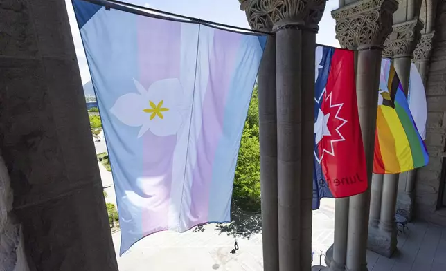 The newly adopted city flags are displayed at the Salt Lake City and County building showing support for LGBTQ+ in defiance of their state's Republican controlled Legislature, Wednesday, May 7, 2025, in Salt Lake City. (AP Photo/Melissa Majchrzak)