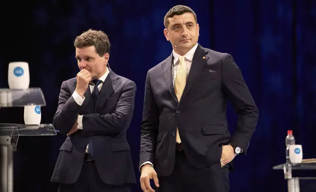 FILE - Presidential candidates Nicusor Dan, left, and George Simion take a break during a live electoral debate ahead of the second round of the country's presidential election redo in Bucharest, Romania, Thursday night, May 8, 2025. (AP Photo/Vadim Ghirda, File)