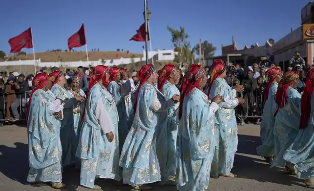 Traditional dancers join a parade during the annual Rose Festival in Kalaat M'Gouna, Morocco, Wednesday, May 7, 2025. (AP Photo/Mosa'ab Elshamy)